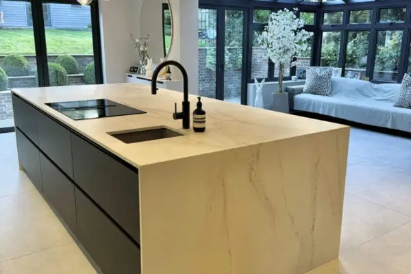 Dark grey kitchen with statement island and large rooflight bringing in natural light